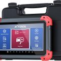 XTOOL automotive diagnostic scanner with touchscreen interface displaying multiple functions