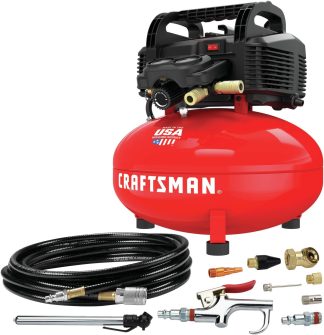 Red Craftsman air compressor with accessories for car detailing, including coiled hose and various nozzles, labeled 'Made in the USA with global materials'