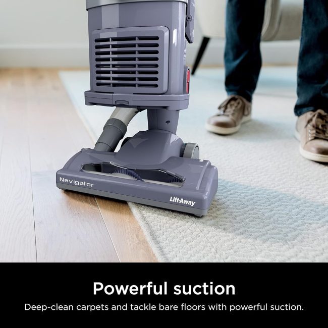 Close-up of Navigator Lift-Away vacuum cleaner being used on a carpet, showcasing its powerful suction for carpets and bare floors