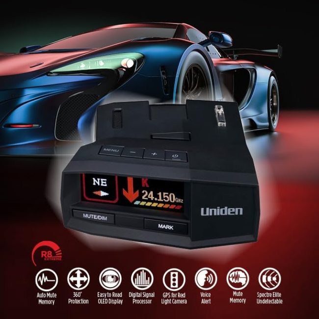 Uniden radar detector placed in front of a sports car, displaying frequency and icons for auto mute memory, 360° protection, OLED display, GPS alerts, voice alert, and Spectre Elite undetectability