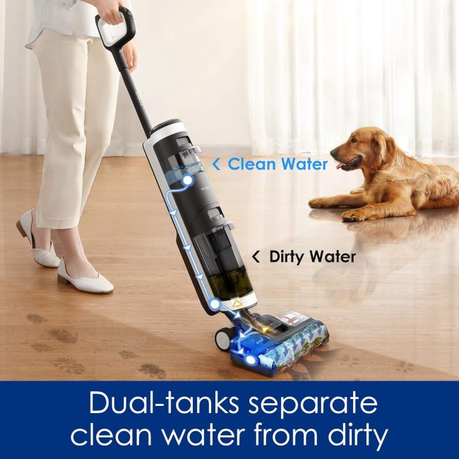 Person using dual-tank vacuum cleaner on wooden floor with dog in background