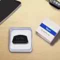Vgate iCar Pro OBDII Diagnostic Device in Packaging on Desktop with Smartphone and Car Key