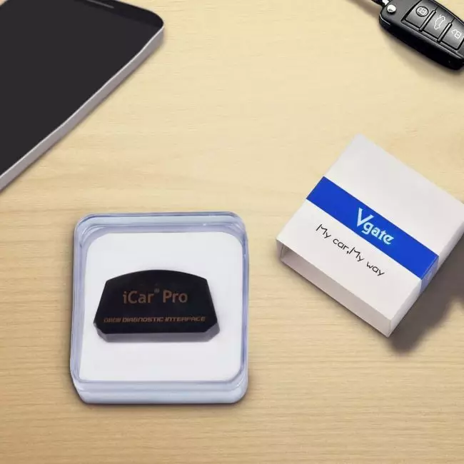 Vgate iCar Pro OBDII Diagnostic Device in Packaging on Desktop with Smartphone and Car Key