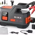 Biuble portable jump starter and tire inflator with digital display and accessories like jumper clamps,   USB charger,   various nozzles,   and car charger adapter
