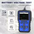 OBD2 code reader displaying battery voltage and diagnostic functions with control buttons