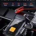 Powerful UIBI portable jump starter with digital display connected to a car battery