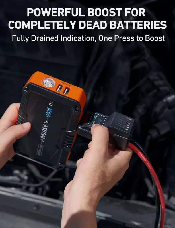 Portable Jump Starter for Dead Car Batteries – Compact Design with USB Ports Person using a portable jump starter on a dead car battery; device features black and orange design with USB outputs