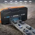 AstroAI 12V-1500A Jump Starter showing universal compatibility with various vehicles like SUVs,   pickups,   and motorcycles,   set against a rugged terrain