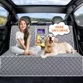 Child and dog on a quilted car seat cover in a car interior with scenic view