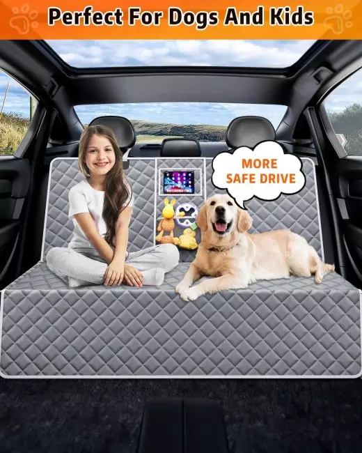 Child and dog on a quilted car seat cover in a car interior with scenic view