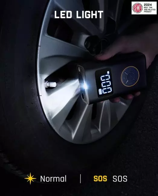 Person using a portable device to inflate car tire with digital display showing air pressure and LED light for visibility