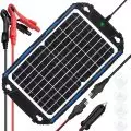 Solar battery charger featuring a solar panel, alligator clips, 12V car charger plug, and suction cups for mounting